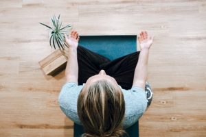 A woman meditating, viewed from top